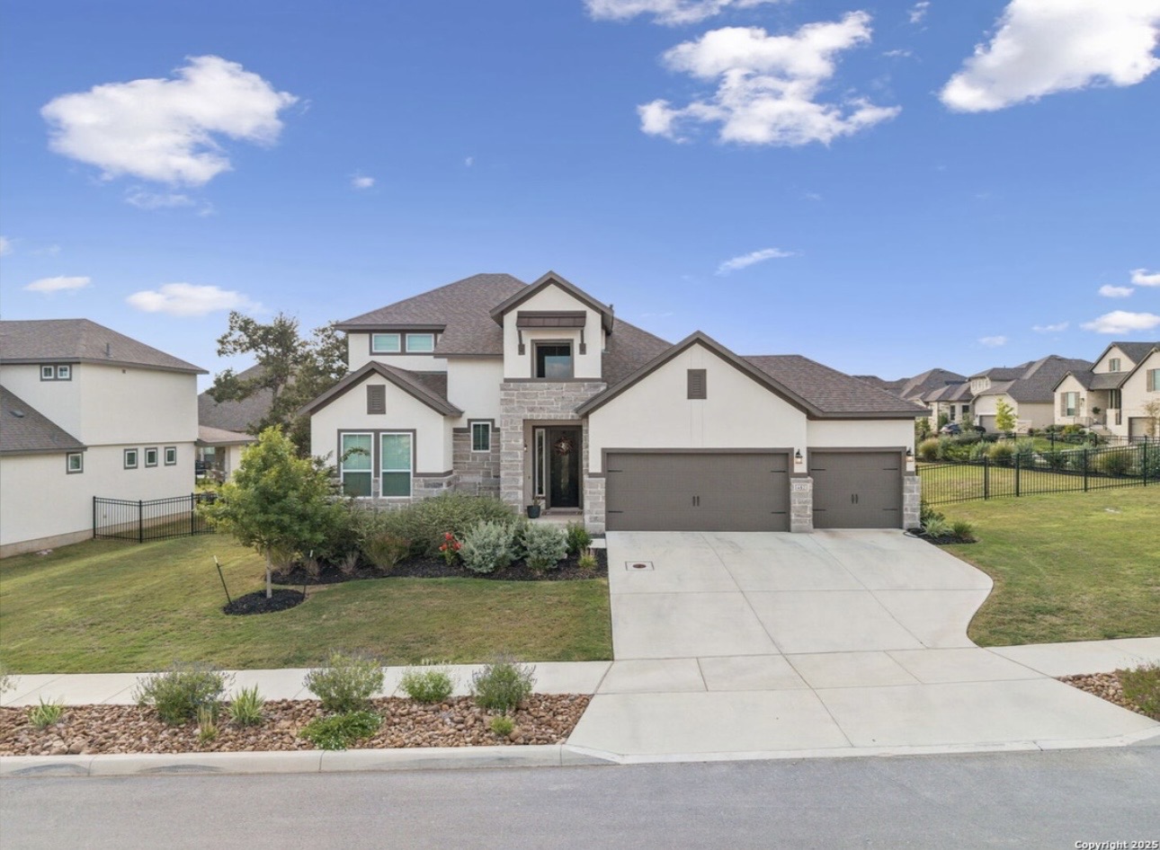 Esperanza Residence daytime exterior with two-car garage and manicured lawn