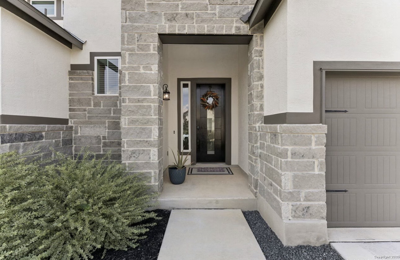 Esperanza Residence arrival — stone and stucco exterior entrance with recessed entryway